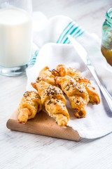 Close up of homebaked mini croissants covered with seeds mix. Morning breakfast.