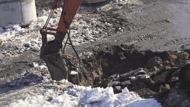 Breaker (hydraulic) cuts frozen soil Timelapse stock footage video