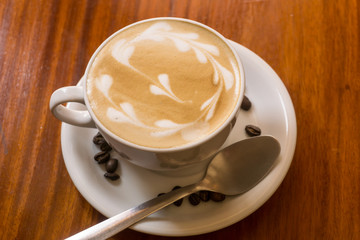 cup of coffee on wooden table