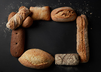 Different kinds of bread on background