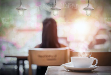 White cup of hot coffee on the table in coffee shop