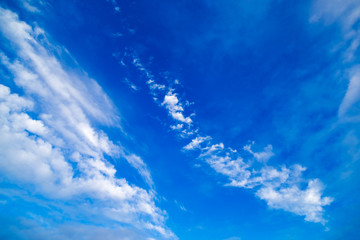 Blue sky with streaks of White clouds