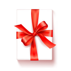 Gift box. White box with a red satin bow. Bright Tape Decorates a Gift.