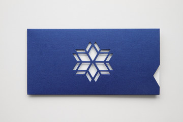Greeting card design mock up, envelope from design paper with star or snowflake die-cut , isolated on white background, close up