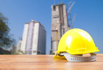 Safety helmet with construction site background
