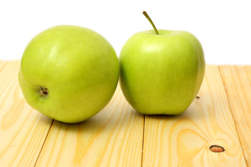 Green apple on wood table isolated on white background