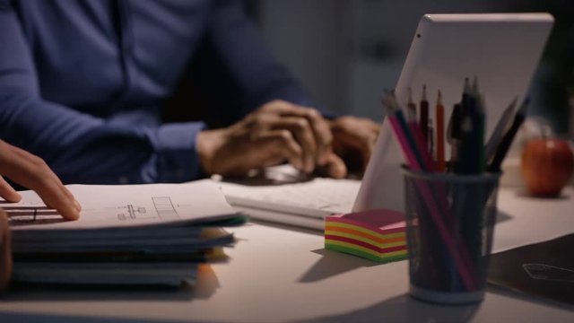 Overworked businessman working late is given extra pile of paperwork