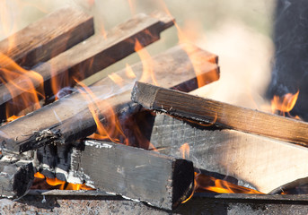 Firewood is burning in the grill
