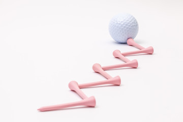 White golf balls and wooden tees