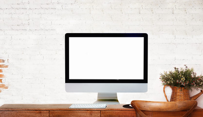 Modern Desktop Computer showing Blank Screen on wood Table over Brick wall. For Graphic or Product Montage.
