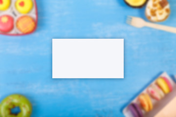 Business card mockup. Macaroons, Cupcakes and glazed donut. Sweet dessert. Cakes with nuts cream. Almond macaron cookies.