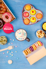 Macaroons, cupcakes and donuts. Mug with whipped cream and marshmallows. Almond macaron cookies. Sweet dessert.