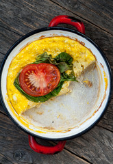 Baked omelet with cheese, spinach and tomatoes