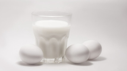 Milk in a glass jar and eggs