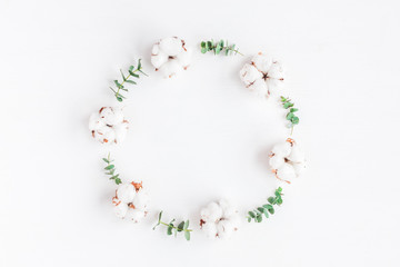Flowers composition. Wreath made of fresh eucalyptus branches and cotton flowers. Flat lay, top view