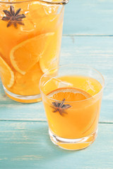 Orange juice with orange slices and anise.