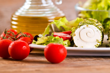 Goat cheese with salad and cherry tomatoes.