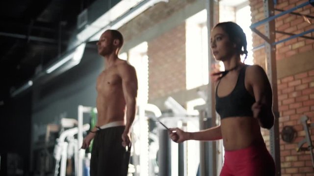 Young couple training with jump ropes 