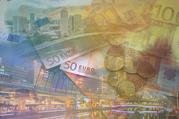 Double exposure of city, banknote and coins money for finance and business concept