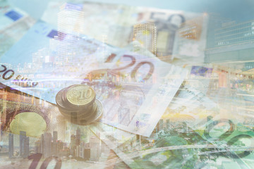 Double exposure of city, banknote and coins money for finance and business concept