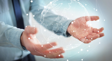 Fototapeta premium Businessman holding global network on planet earth 3D rendering