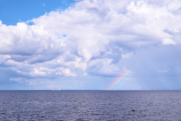Fototapeta na wymiar Beautiful seascape. Rainbow on horizon.