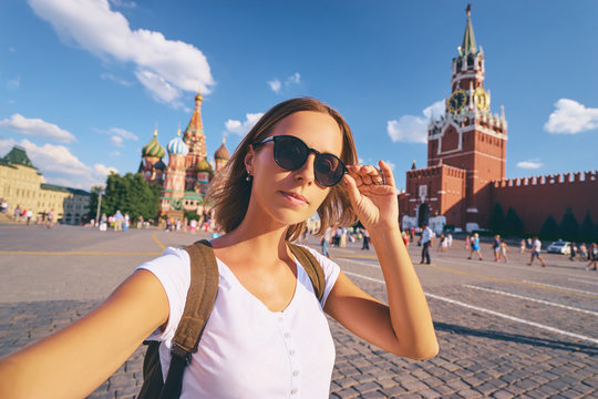 Travel and technology. Happy young woman taking selfie on Red Square in Moscow, Russia.