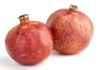 Juicy pomegranate and its half. Ripe pomegranate fruit isolated on white background. Fruit. Healthy food. Vitamins.