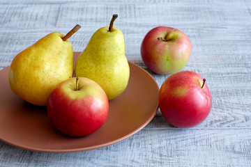 Apples and pears on a wooden table