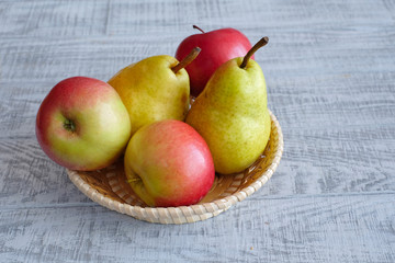 Apples and pears on a wooden table