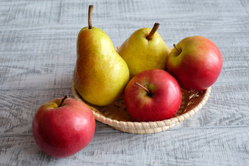Apples and pears on a wooden table