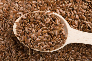 close up of flax seeds isolated on white background. Bowl full of brown flaxseed or linseed. Cereals. Vitamins. Healthy food.