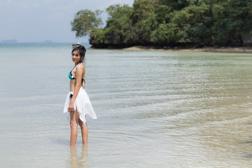Fototapeta premium Beautiful young girl on tropical island beach