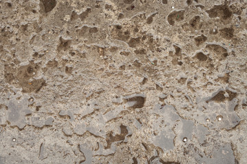 Rough wet concrete surface with water