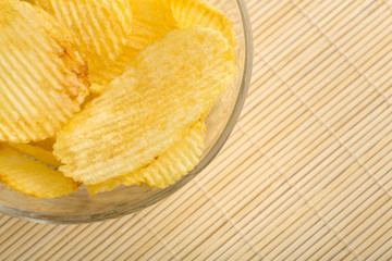 Crispy potato chips. Fast Food. Potatoes. Fatty unhealthy foods. corrugated chips