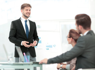 Successful business man in suit at the office leading a group