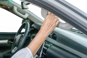 Elderly woman on car