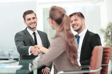 Handshake between business people in a modern office