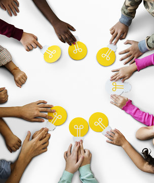 Aerial group of kids hands holding light bulb icon