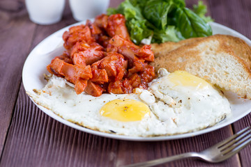 Ready for eat breakfast with sausage, eggs and toasts