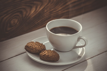 Cup of hot espresso and cookies