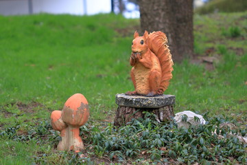 Sculpture of a red squirrel sitting on a stump