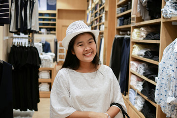Beautiful young asian woman smiling and happy with her's new white hat