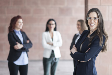 Successful smiling business woman leading a business group