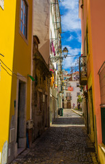 Fototapeta na wymiar Narrow colourful street in Lisbon