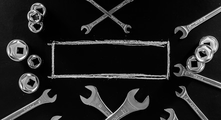 Black chalkboard with wrenches, service. Blackboard. Blank border for text.