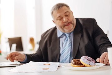 Hungry burned out employee thinking about his lunch break