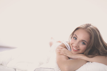 Beautiful young women lying on bed at home