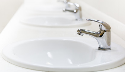 faucet and sink in a public toilet