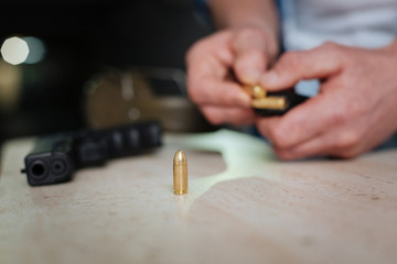 Selective focus of a bullet standing on the table